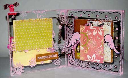 baby scrapbook with wings drawn with scrapbooking pens